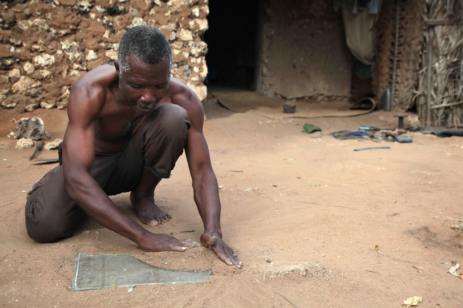 If you need to cut glass but don't have a glass cutter, first cover the glass in a layer of sand...