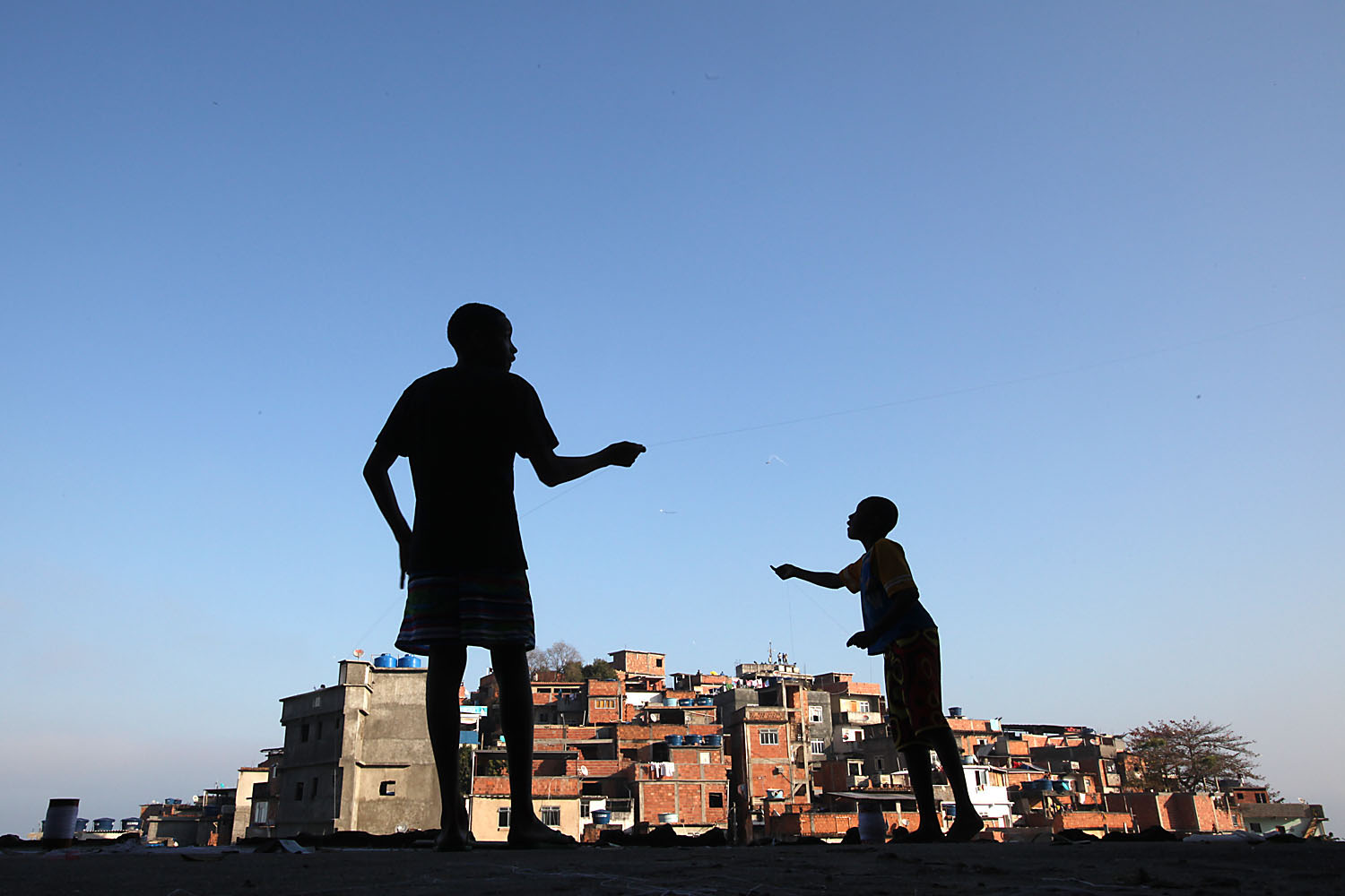 Boys fly kites in Cantagalo.